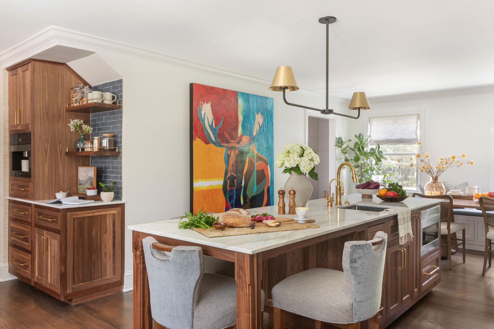 Walnut kitchen island with curated art and custom millwork