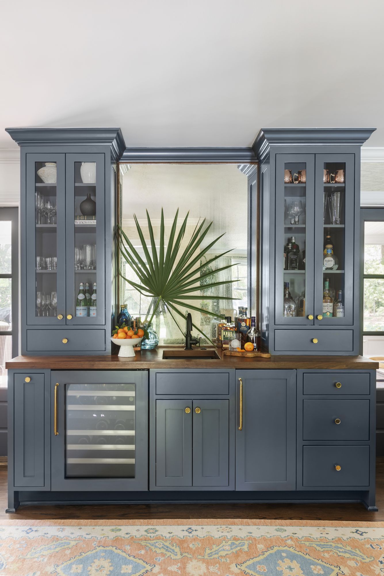 Bespoke blue bar cabinetry with brass details